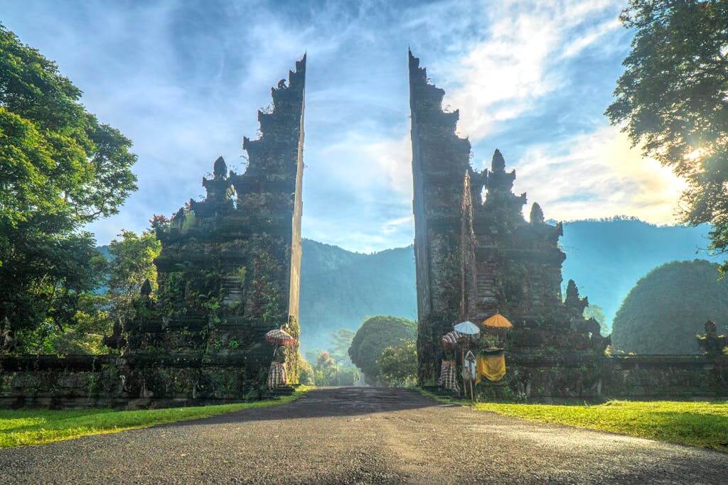 Stunning view of the Handara Gate in Bali, Indonesia with mountains and lush greenery.