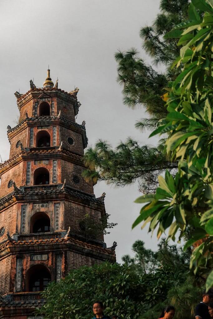 Beautiful view of Thien Mu Pagoda, a historic Buddhist temple in Hue, Vietnam, surrounded by lush greenery.